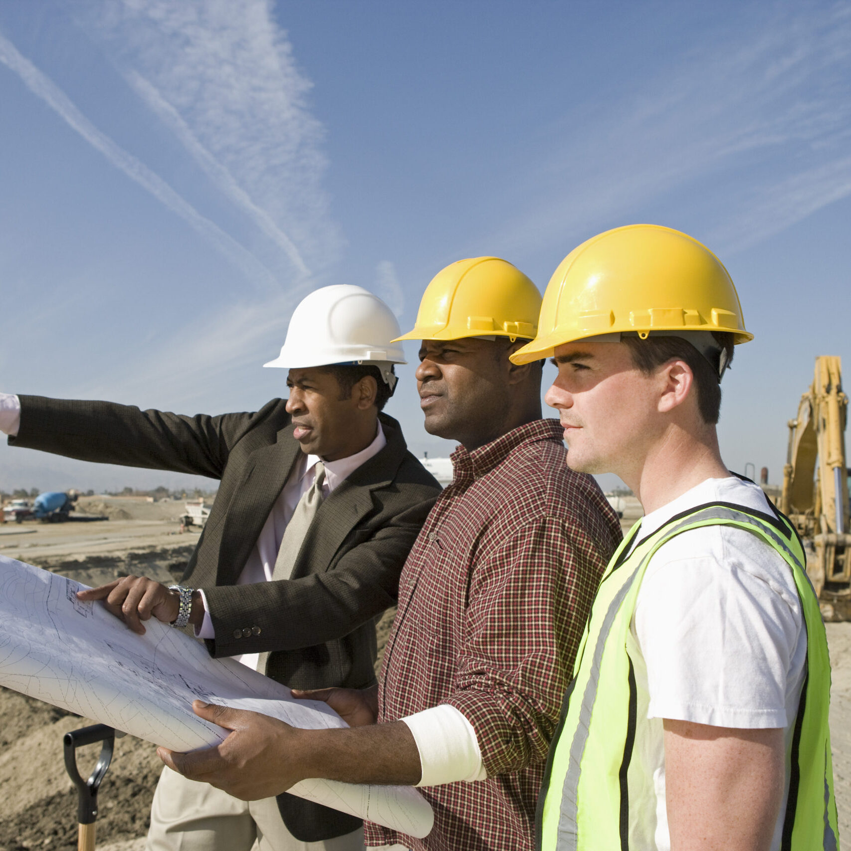 Surveyor and construction workers on site